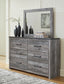 Bronyan King Panel Bed with Mirrored Dresser, Chest and 2 Nightstands